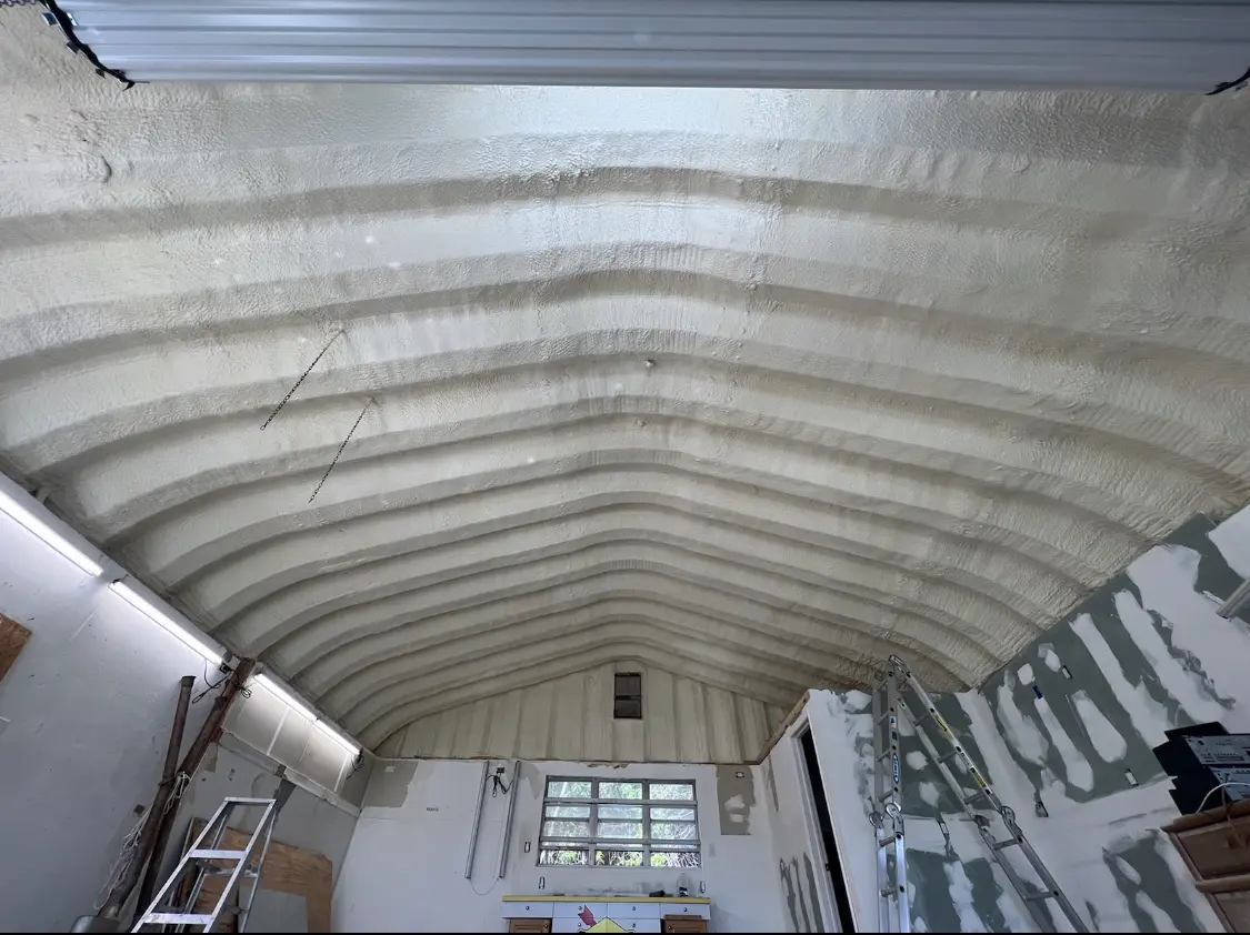 Spray polyurethane foam applied to the underside of a metal roof deck in Caddo Mills